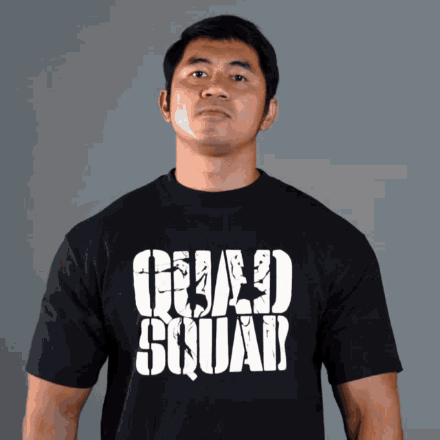 a man wears a black t-shirt that says squad