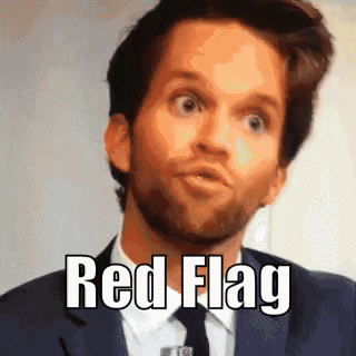 a man in a suit and tie is making a funny face with the words red flag above him