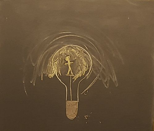 a chalk drawing of a light bulb with a stick figure inside of it