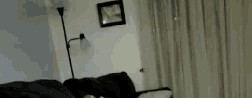 a living room with a couch and a lamp and a picture on the wall