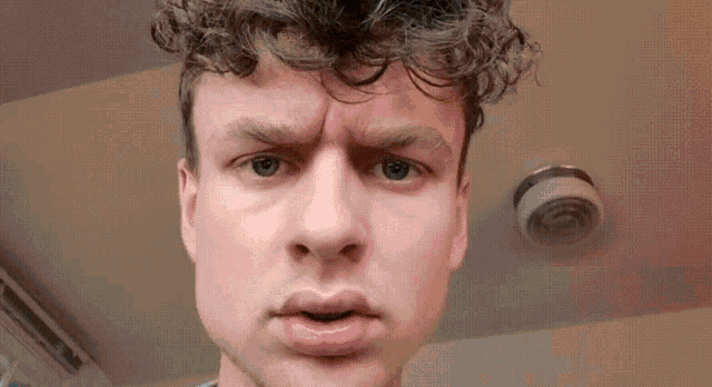 a close up of a man 's face with a camera in the background .