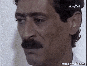 a close up of a man with a mustache making a face .