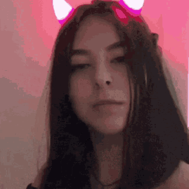 a girl wearing devil horns and a veil .