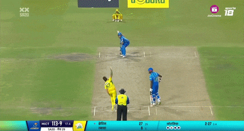 a man in a yellow and green van crazed jersey points at something