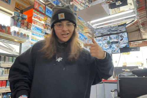 a woman wearing a black sweatshirt with the letter mf on the front