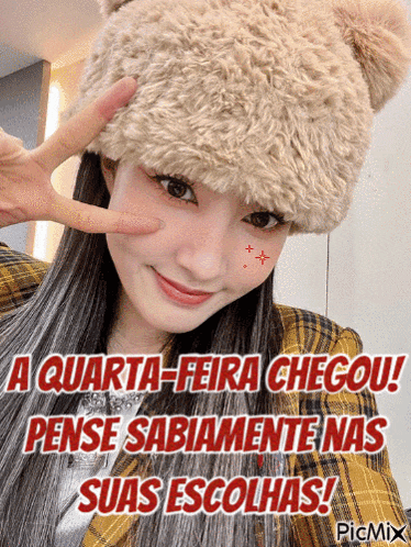a woman wearing a furry hat is making a peace sign with her finger
