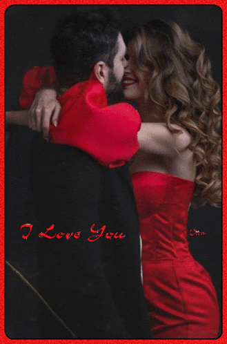 a woman in a red dress is hugging a man in a black suit with the words i love you on the bottom