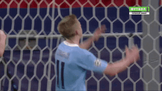 a soccer player in a blue jersey with the number 11 on it
