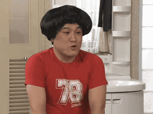 a man wearing a red shirt that says 78 on it