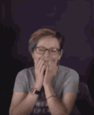 a woman wearing glasses and a t-shirt that says `` friends helping friends '' is singing a song .