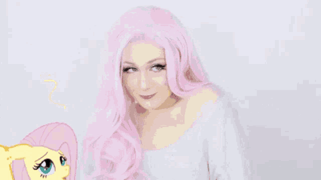 a woman in a pink wig is standing in front of a drawing of a pony .
