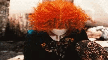 a person with red hair is wearing a black sweater