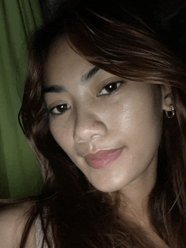 a close up of a woman 's face with brown hair