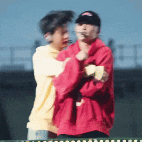 a blurry picture of two people standing next to each other