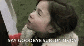 a little girl is holding a book and saying `` say goodbye subjuntivo '' .