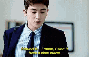 a man in a suit and tie is talking about winning a claw crane .