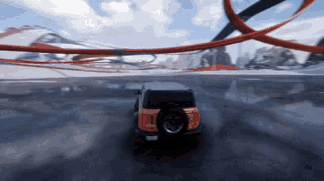 a jeep is driving down a road with a tire that says ' i ' on it
