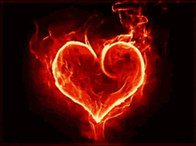 a red heart is surrounded by flames and smoke
