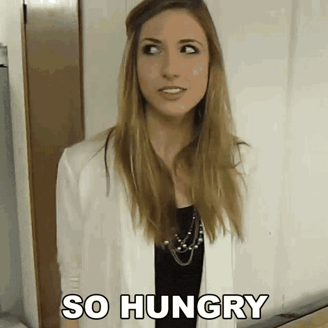 a woman says she is so hungry while looking at the camera