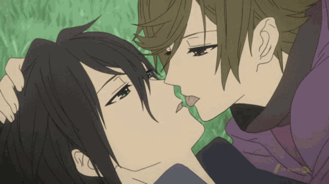 a couple of anime characters kissing with a tv channel logo in the lower right corner