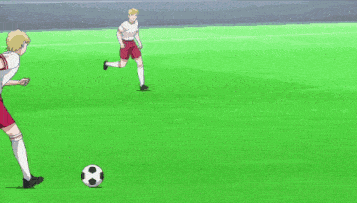 a person with red socks kicking a soccer ball on a field