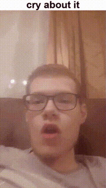 a man wearing glasses is making a funny face and crying about it .