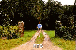 a man is running down a dirt road with the words `` rtb '' written on the side .