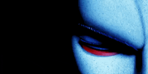 a close up of a person 's eye with red eyes