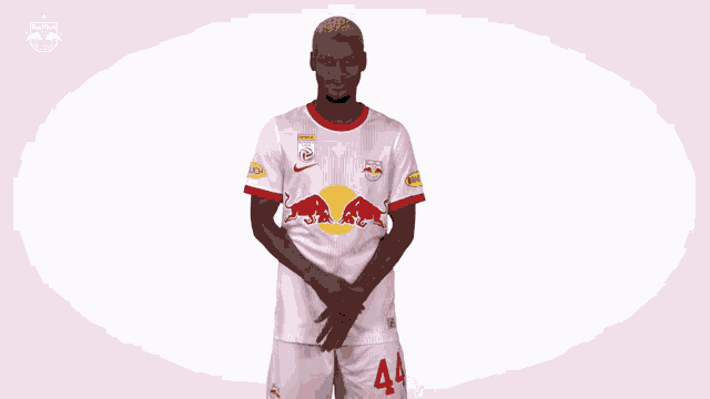 a man wearing a red bull jersey is clapping