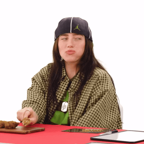 a woman wearing a plaid shirt and a hat with an air jordan logo