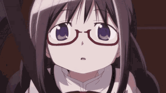 a close up of a girl wearing glasses with purple eyes .