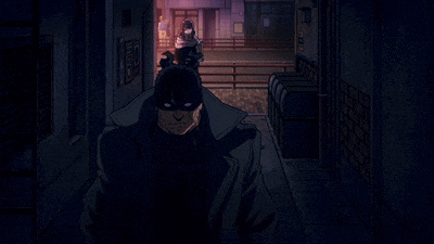 a man in a mask is walking down a hallway