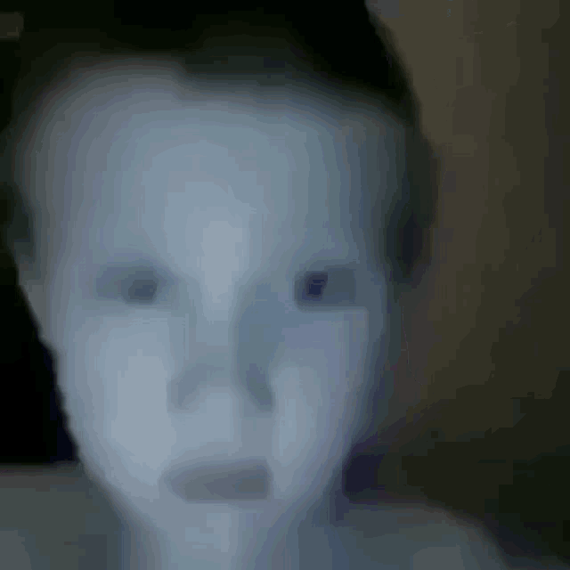 a blurry picture of a person 's face with their eyes closed