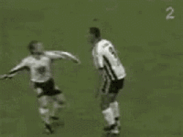 a group of soccer players are playing on a field with the number 2 in the background