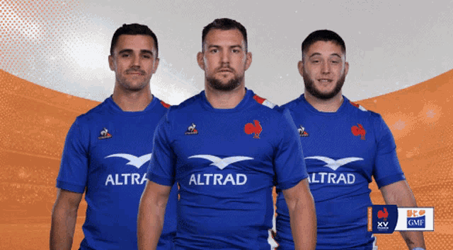 three men wearing blue shirts that say altrad on them