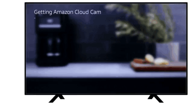 a tv screen shows a blurred image and the words " getting amazon cloud cam " on the bottom