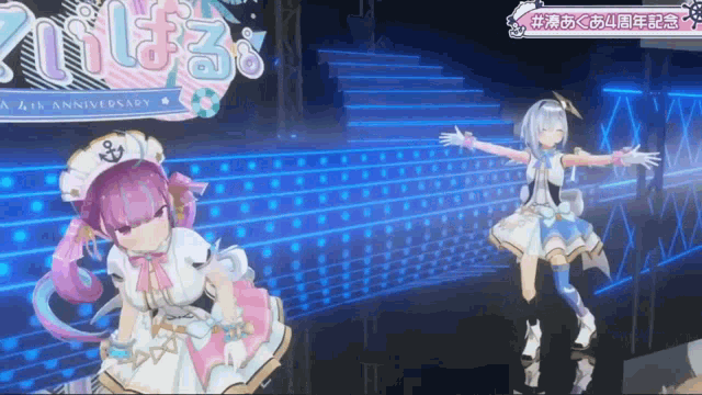 two anime girls are dancing on a stage with a 4th anniversary sign in the background