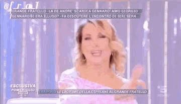 a woman is making a funny face on a television screen .