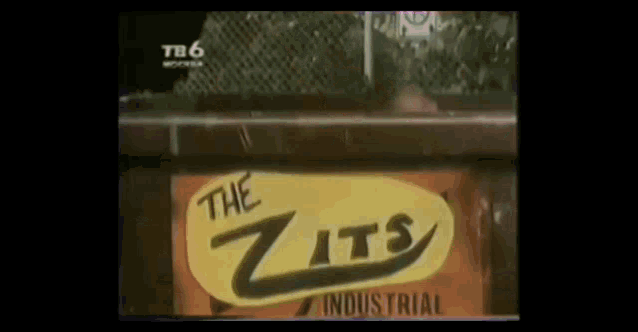 a yellow sign that says " the zits industrial " on it