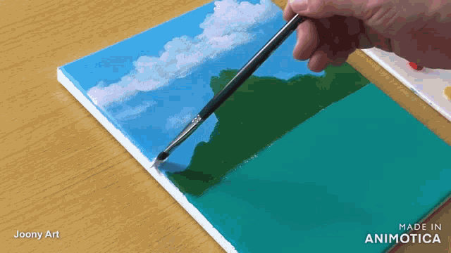 a person is painting a landscape with a brush and the words made in animatica are visible