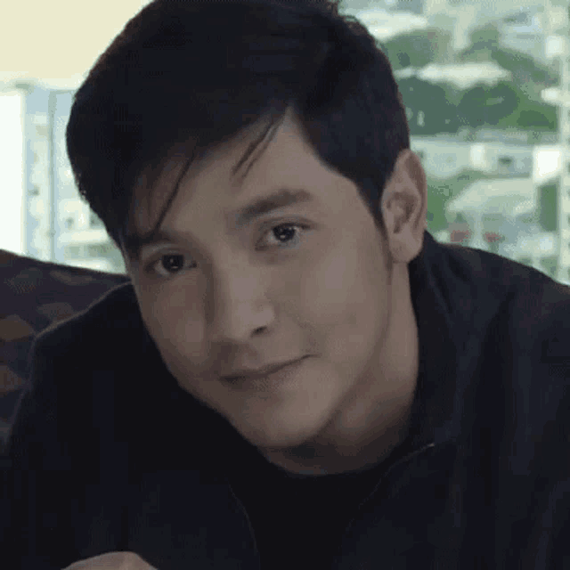 a close up of a young man 's face with a serious look on his face