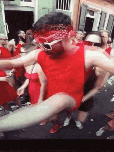a man in a red leotard with a bandana on his head