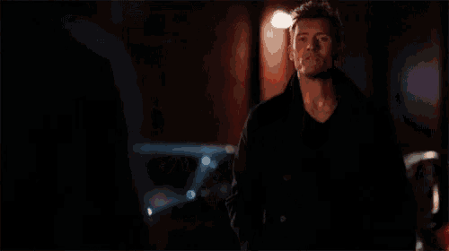 a man with blood on his face is standing next to a man with blood on his face .