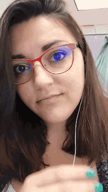 a close up of a woman wearing glasses and earbuds