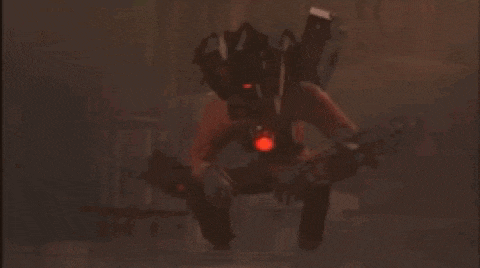 a robot with red lights on its arms is standing in a dark room with a fire in the background .