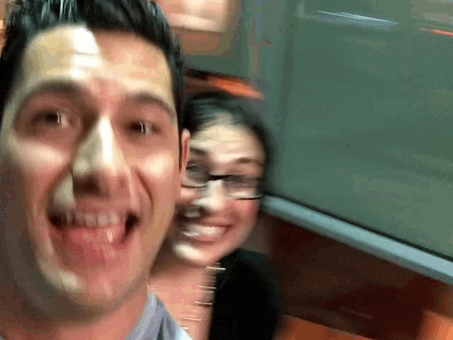 a man and a woman are posing for a picture and the man is making a funny face