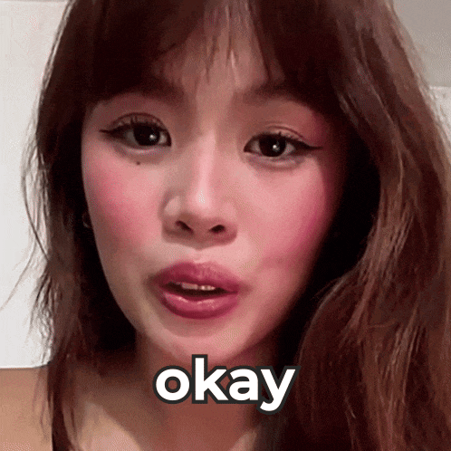 a close up of a woman 's face with the word okay written on it .