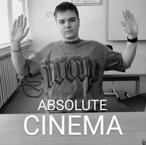 a man in a t-shirt that says absolute cinema on it