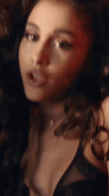 a close up of a woman 's face with a red light behind her