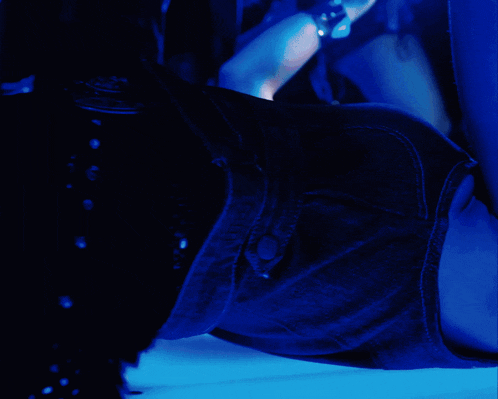 a blue light is shining on a person 's torso